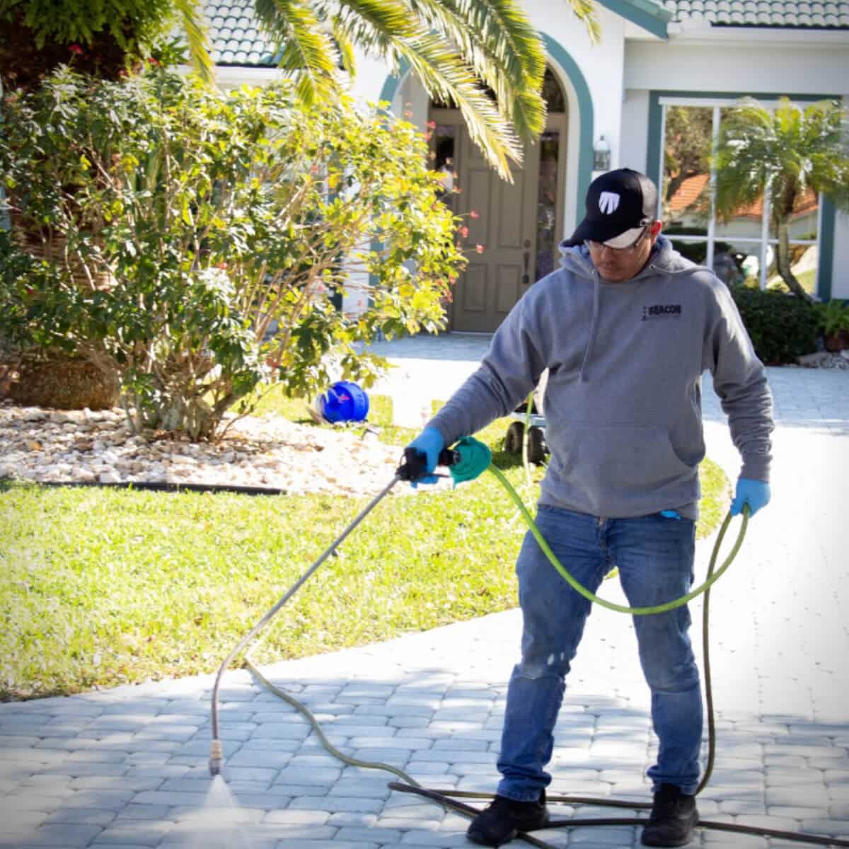 expert pressure washer cleaning sidewalk in residential area of rockledge fl